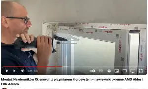 Montaż nawiewników okiennych z przyrządem Higrosystem. Widać mężczyznę wiercącego otwory w ramie okiennej, przygotowując miejsce na wywietrzniki w oknach.
